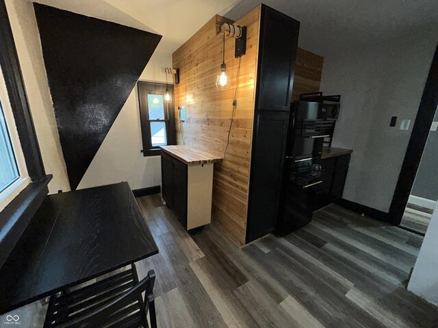 1627 E 8th St, Anderson, IN 46012 - kitchen with wood counters, wooden walls, baseboards, and dark wood-style floors