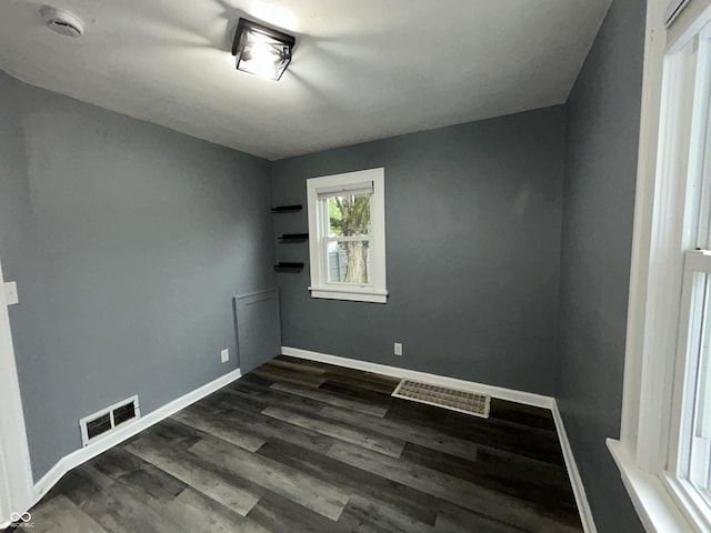1627 E 8th St, Anderson, IN 46012 - empty room featuring dark wood-style flooring, baseboards, and visible vents