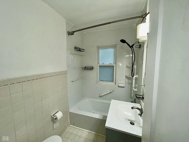 1627 E 8th St, Anderson, IN 46012 - full bath with tile walls, toilet, vanity, wainscoting, and shower / bath combination