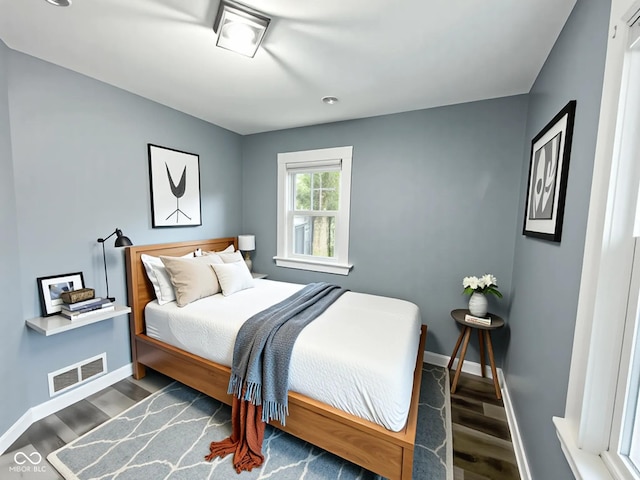 1627 E 8th St, Anderson, IN 46012 - bedroom with visible vents, wood finished floors, and baseboards