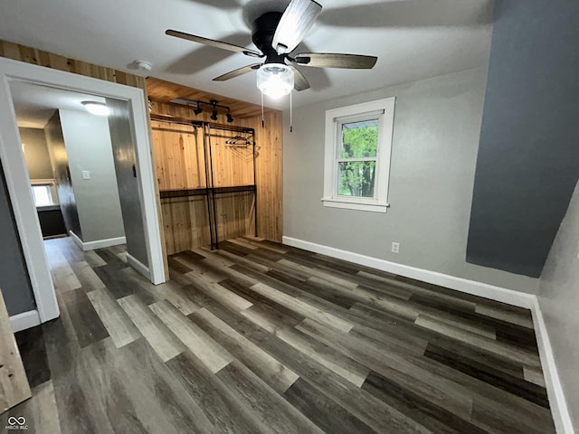 1627 E 8th St, Anderson, IN 46012 - unfurnished bedroom with a closet, baseboards, a ceiling fan, and dark wood-style floors