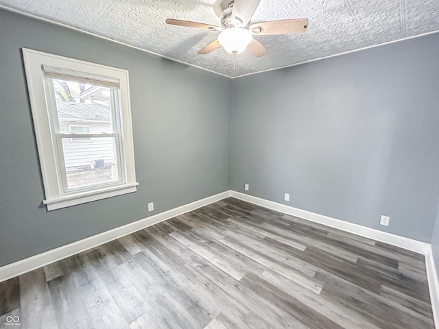1627 E 8th St, Anderson, IN 46012 - unfurnished room with wood finished floors, baseboards, and ceiling fan