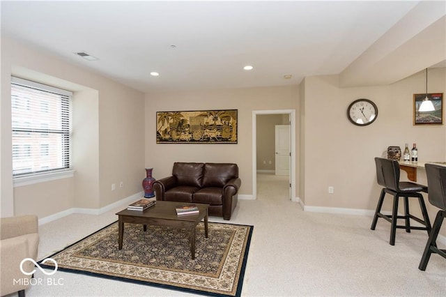 carpeted living room featuring visible vents, baseboards, and recessed lighting