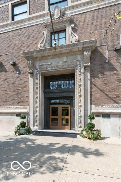 entrance to property featuring brick siding and french doors