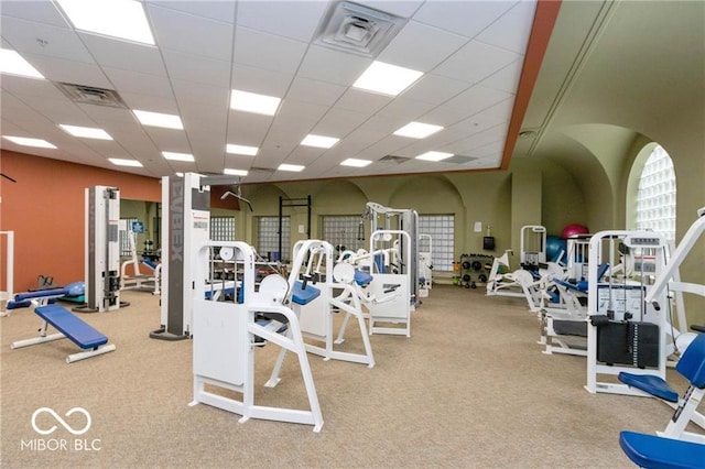 exercise room with carpet, visible vents, and a drop ceiling