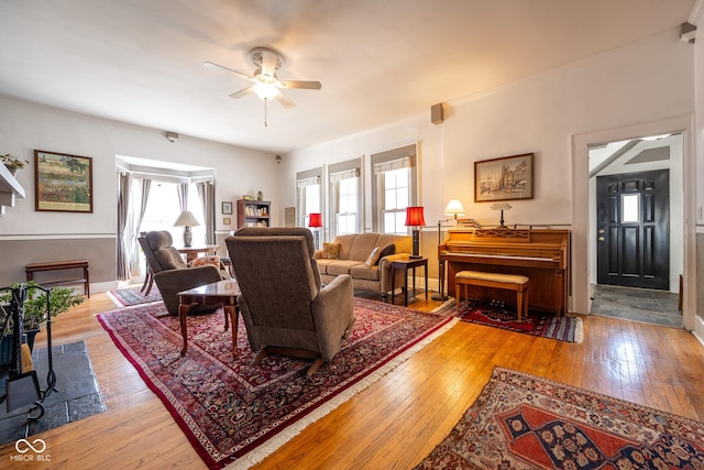 living area featuring a ceiling fan and hardwood / wood-style flooring