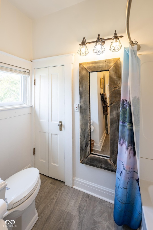 bathroom featuring toilet and wood finished floors