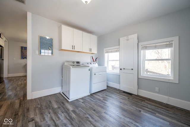 washroom with cabinet space, separate washer and dryer, baseboards, dark wood-type flooring, and visible vents