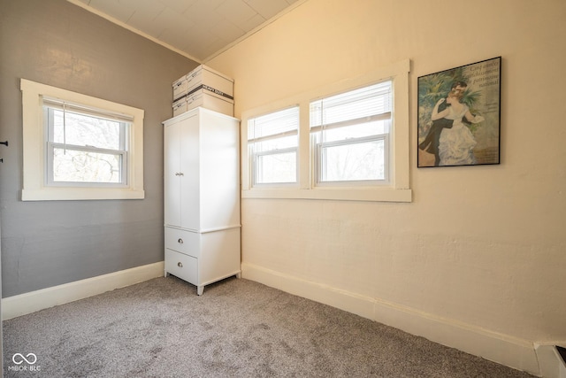 unfurnished bedroom featuring carpet floors, baseboards, and ornamental molding