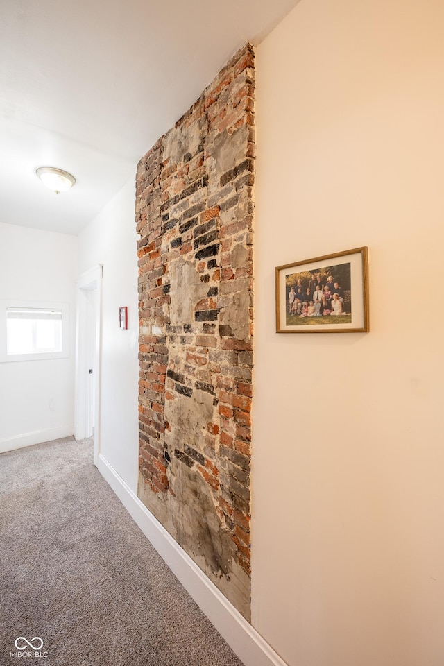 corridor featuring carpet flooring and baseboards