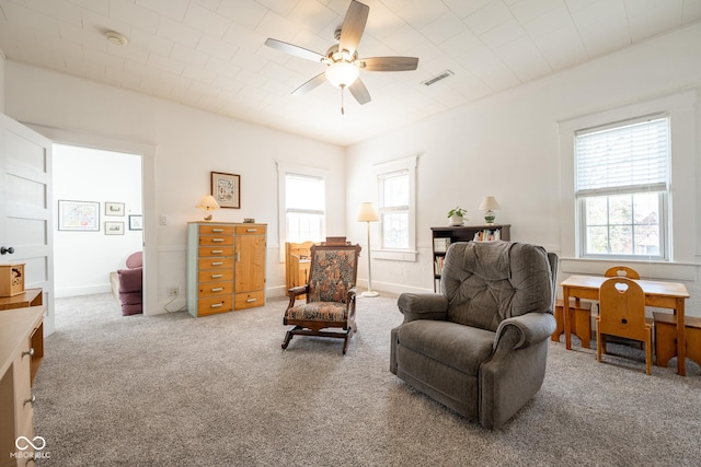 sitting room with visible vents, carpet, ceiling fan, and baseboards