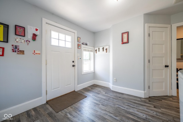 entrance foyer featuring baseboards and wood finished floors