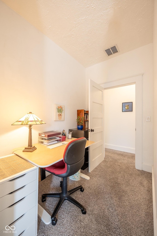 office featuring carpet floors, a textured ceiling, and visible vents