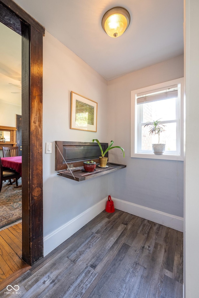 interior space with baseboards and wood finished floors
