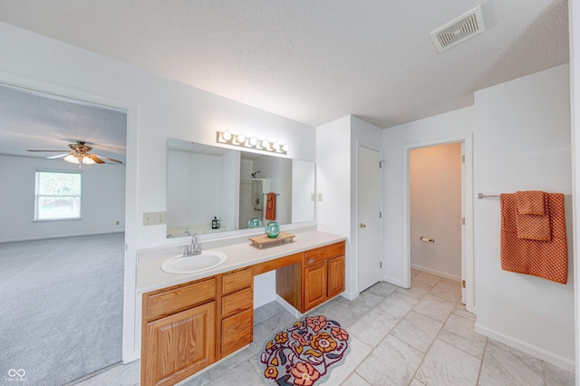 5989 Ashmore Ln, Carmel, IN 46033 - bathroom with an enclosed shower, vanity, ceiling fan, a textured ceiling, and baseboards