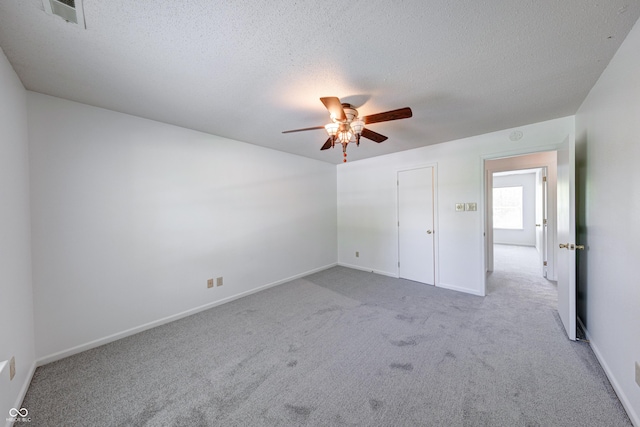 5989 Ashmore Ln, Carmel, IN 46033 - unfurnished bedroom featuring carpet flooring, a textured ceiling, a ceiling fan, and baseboards