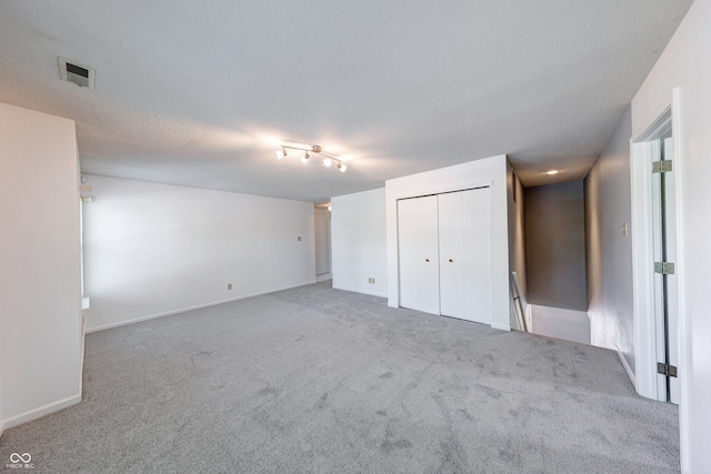 5989 Ashmore Ln, Carmel, IN 46033 - unfurnished bedroom with carpet, a textured ceiling, a closet, and baseboards