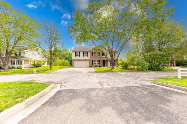 5989 Ashmore Ln, Carmel, IN 46033 - view of front of property featuring brick siding, a garage, a front lawn, and asphalt driveway