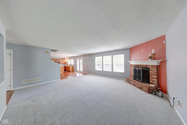 5989 Ashmore Ln, Carmel, IN 46033 - unfurnished living room featuring a fireplace, a textured ceiling, carpet flooring, and baseboards