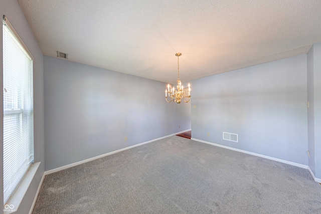 5989 Ashmore Ln, Carmel, IN 46033 - empty room with a chandelier, carpet flooring, and baseboards