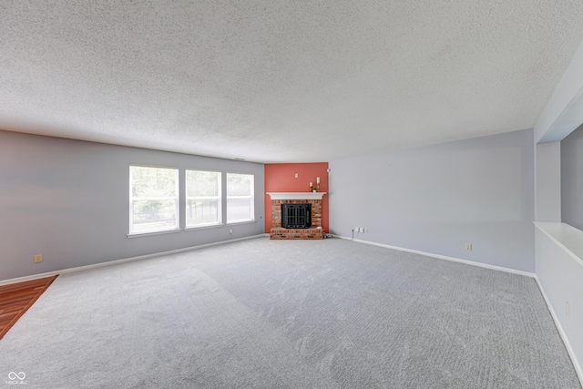 5989 Ashmore Ln, Carmel, IN 46033 - unfurnished living room with a textured ceiling, carpet, a fireplace, and baseboards