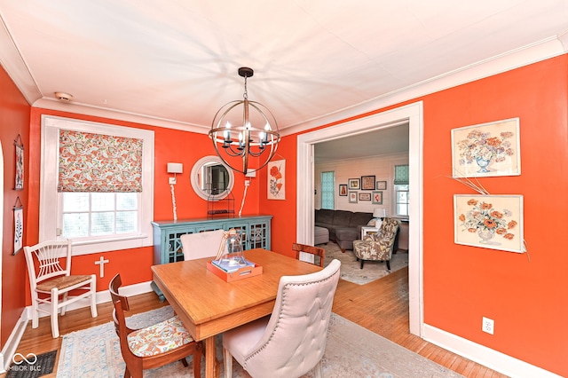 dining room with baseboards, light wood finished floors, and a chandelier