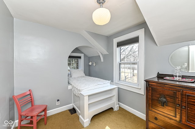 bedroom with carpet floors, baseboards, and multiple windows