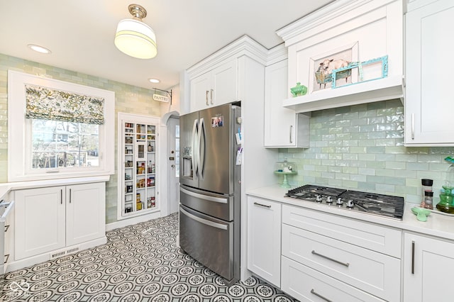 kitchen with visible vents, light countertops, white cabinetry, appliances with stainless steel finishes, and backsplash