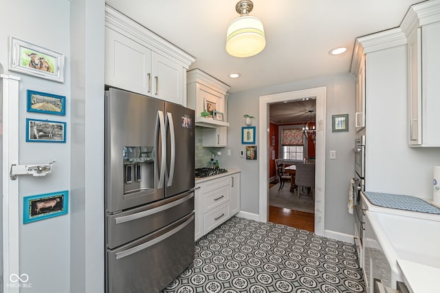 kitchen featuring appliances with stainless steel finishes, tasteful backsplash, baseboards, white cabinets, and recessed lighting