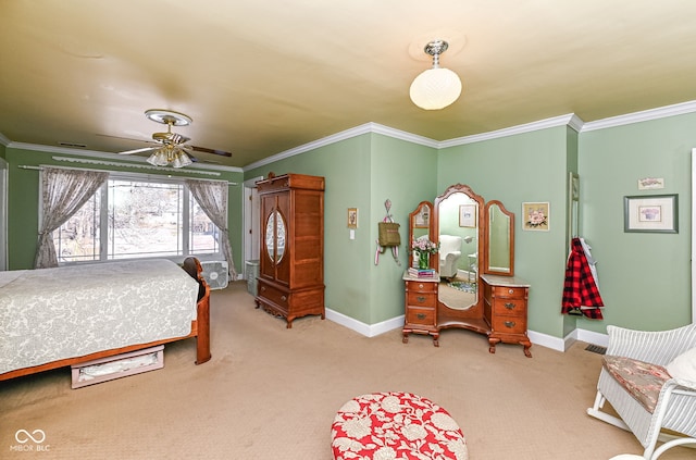 bedroom with crown molding, baseboards, and carpet flooring