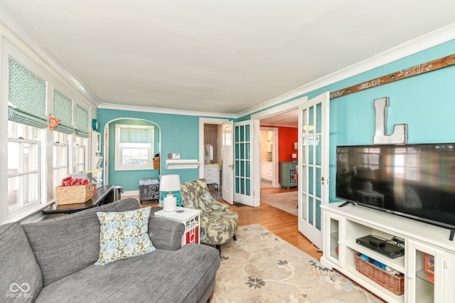 living room featuring ornamental molding, french doors, and wood finished floors