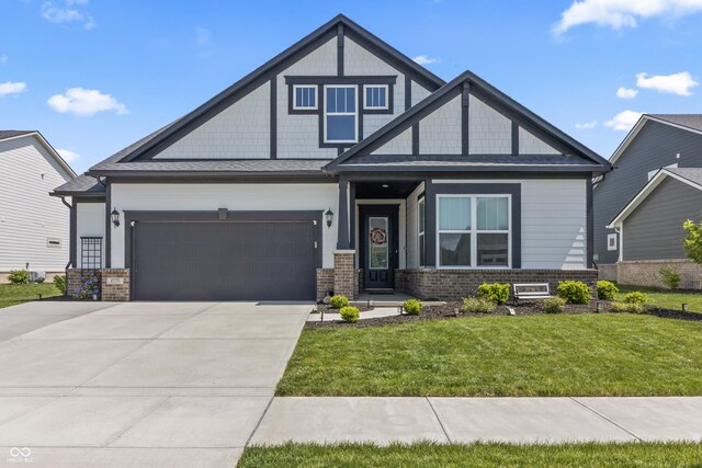15755 Scher Dr, Westfield, IN 46074 - craftsman-style home with brick siding, a front yard, driveway, and an attached garage