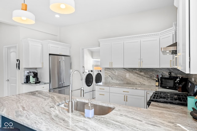 358 Terrace Ave, Indianapolis, IN 46225 - kitchen with tasteful backsplash, a sink, light stone countertops, washing machine and dryer, and black appliances
