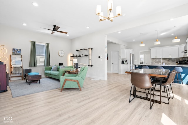 358 Terrace Ave, Indianapolis, IN 46225 - dining area with baseboards, recessed lighting, light wood-type flooring, and ceiling fan with notable chandelier