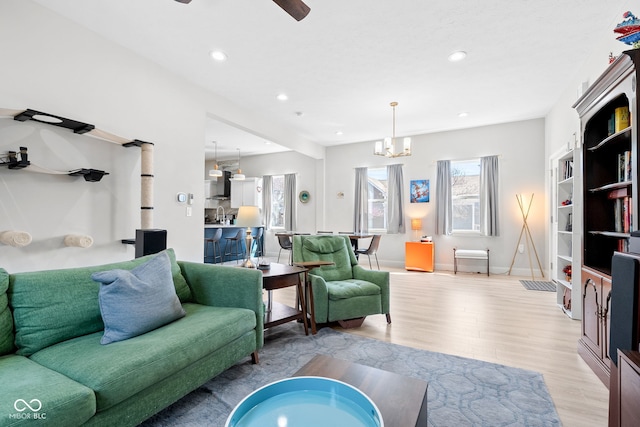 358 Terrace Ave, Indianapolis, IN 46225 - living room featuring recessed lighting, light wood-type flooring, and ceiling fan with notable chandelier