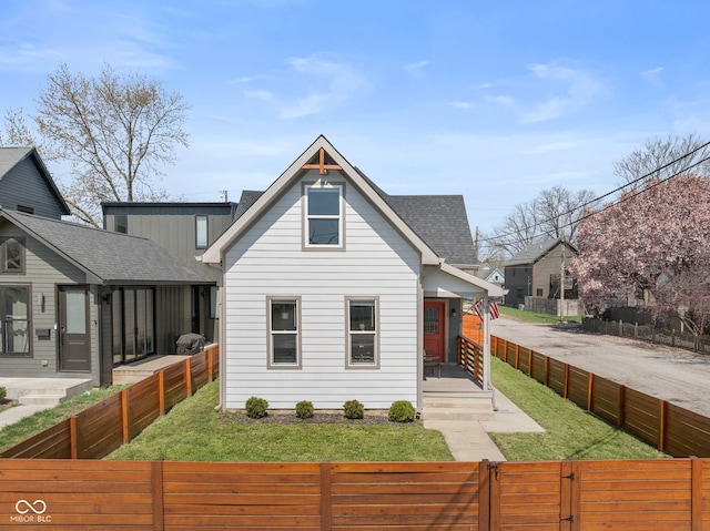 358 Terrace Ave, Indianapolis, IN 46225 - view of front of house featuring a front yard, a gate, a fenced front yard, and roof with shingles