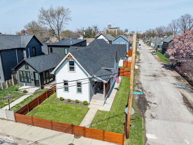 358 Terrace Ave, Indianapolis, IN 46225 - view of front of property with a front lawn, a residential view, a shingled roof, and fence private yard