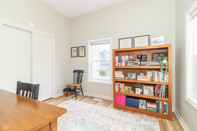 office area featuring visible vents, baseboards, and wood finished floors