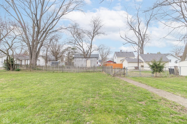 view of yard featuring a residential view, a gate, and fence private yard