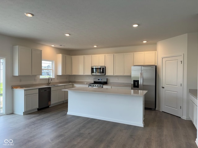 240 Ames Dr, Whiteland, IN 46184 - kitchen with stainless steel appliances, a kitchen island, dark wood-style floors, light countertops, and recessed lighting