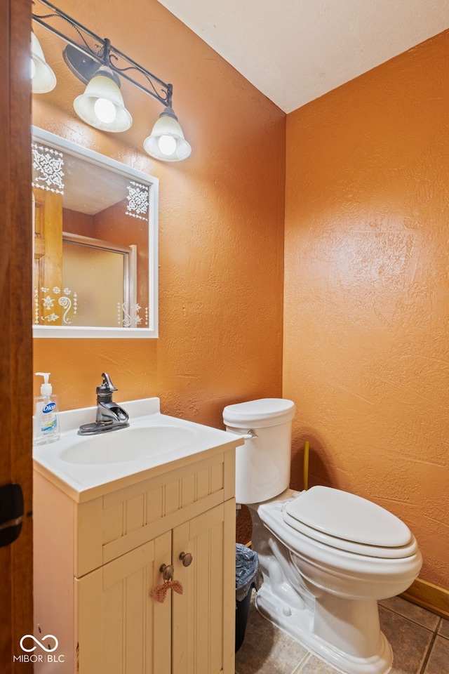 6351 Dixon Rd, Columbus, IN 47201 - bathroom with a shower with door, vanity, a textured wall, tile patterned floors, and toilet