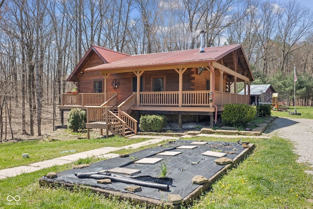 6351 Dixon Rd, Columbus, IN 47201 - view of front of property with a front yard, metal roof, log exterior, and a porch