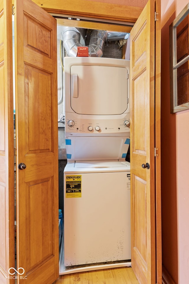 6351 Dixon Rd, Columbus, IN 47201 - clothes washing area with laundry area, stacked washer and clothes dryer, and light wood-type flooring