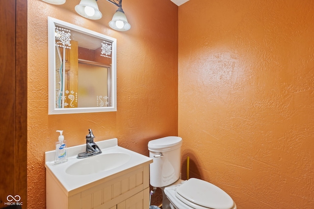 6351 Dixon Rd, Columbus, IN 47201 - full bath with toilet, walk in shower, vanity, and a textured wall