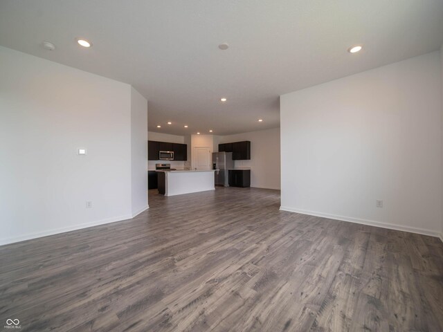 915 Saddlebrook Farms Blvd, Whiteland, IN 46184 - unfurnished living room with dark wood-type flooring and recessed lighting
