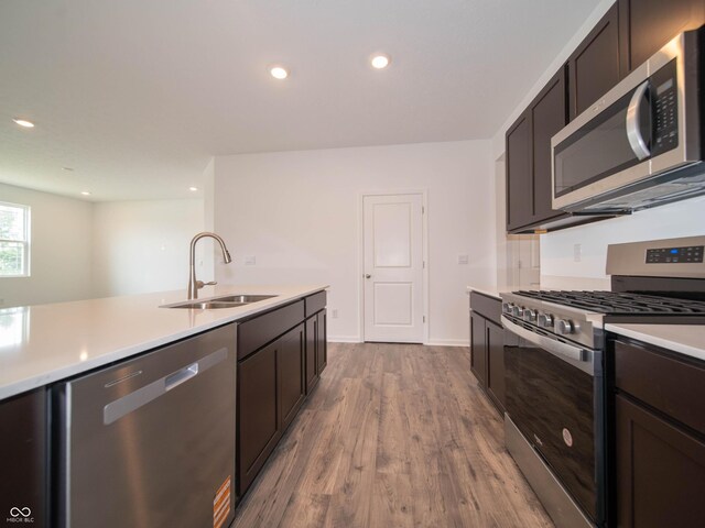 915 Saddlebrook Farms Blvd, Whiteland, IN 46184 - kitchen featuring appliances with stainless steel finishes, light countertops, dark wood finished floors, recessed lighting, and dark brown cabinetry