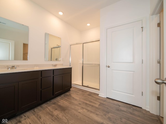 915 Saddlebrook Farms Blvd, Whiteland, IN 46184 - bathroom featuring wood finished floors, double vanity, a stall shower, and recessed lighting