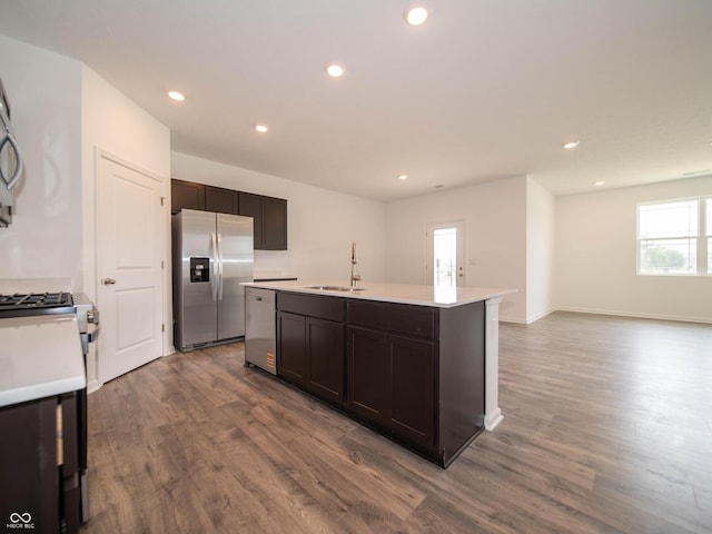 915 Saddlebrook Farms Blvd, Whiteland, IN 46184 - kitchen with appliances with stainless steel finishes, dark wood-style flooring, an island with sink, dark brown cabinetry, and light countertops