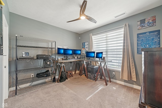 interior space featuring baseboards, visible vents, and ceiling fan