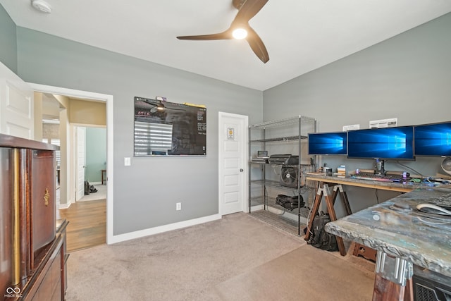 home office with a ceiling fan, carpet, and baseboards